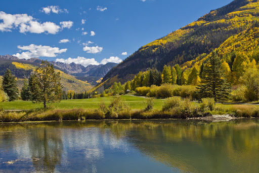Landscape view of the Vail Valley including a pond and the Gore Mountain Range